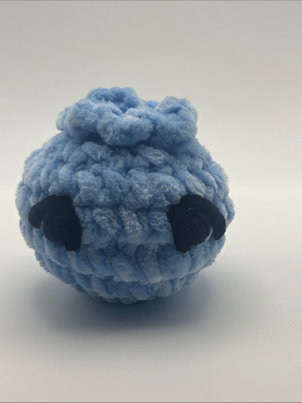 Handmade crocheted blueberry with eyelashes